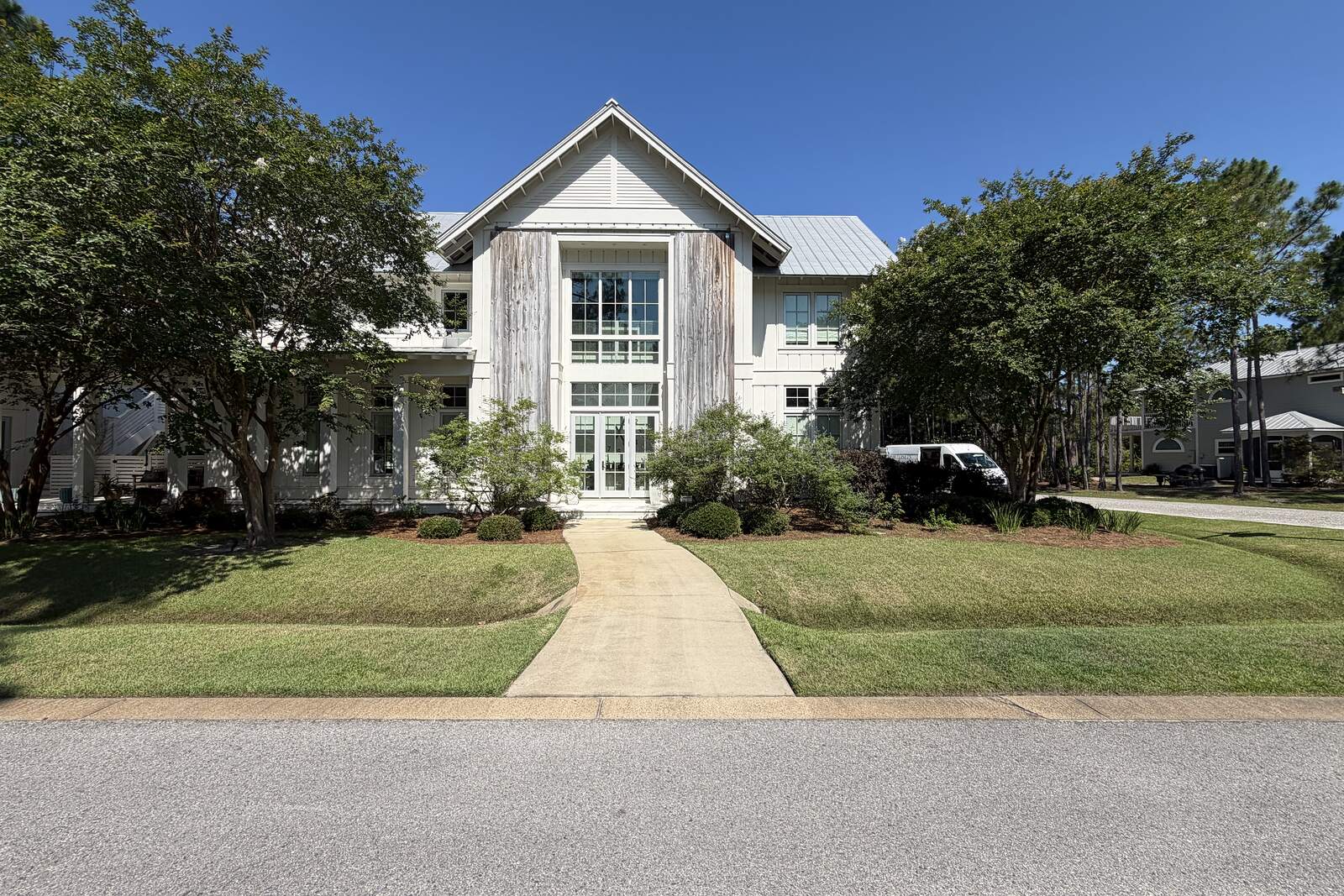 A 30A coastal home with a cut lawn and clean walkway