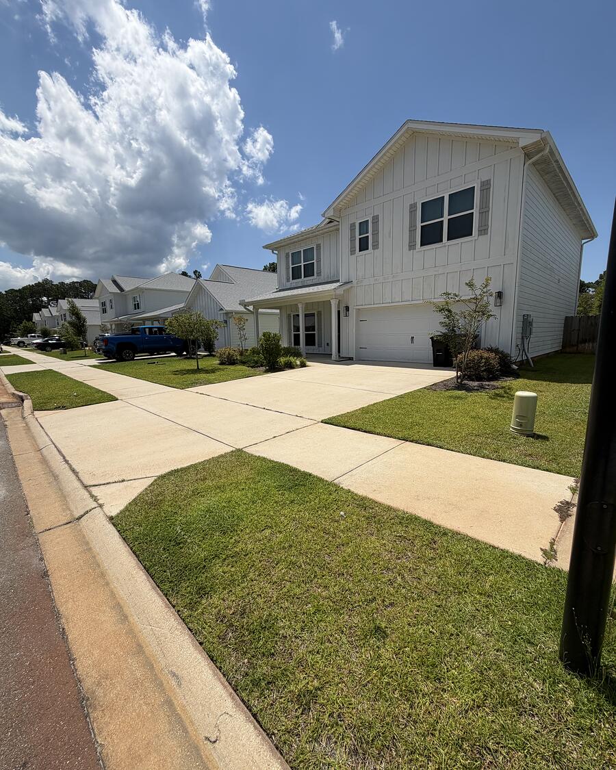 A finished front lawn and walkway at a coastal home