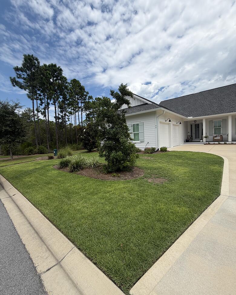 A finished front lawn with a clean walkway edge