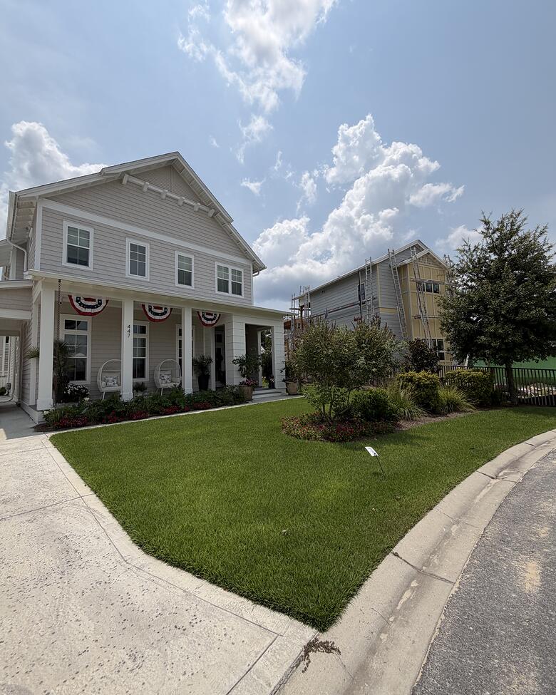 A curved lawn edge running along a sidewalk